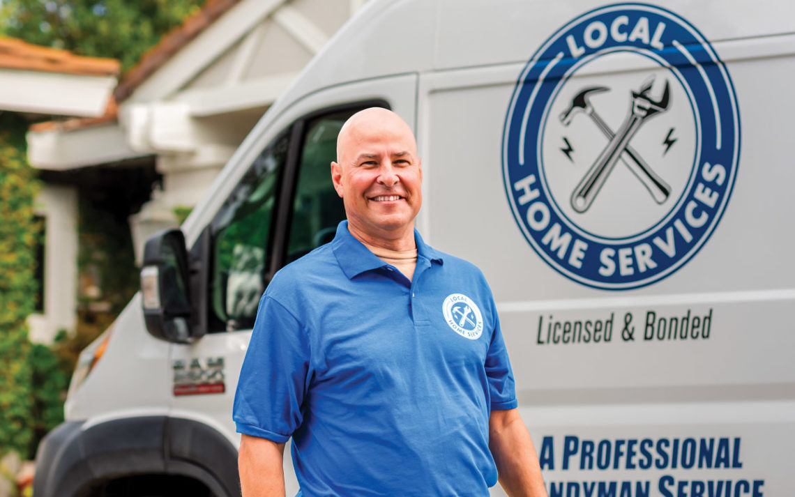 Derek Bingley, owner of Local Home Services, stands in front of his truck.
