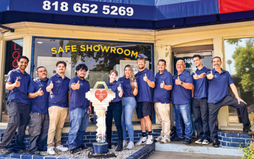 Eli Shirel, owner of Guardian Angel Locksmith, stands in front of his store with employees