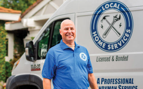 Derek Bingley, owner of Local Home Services, stands in front of his truck.