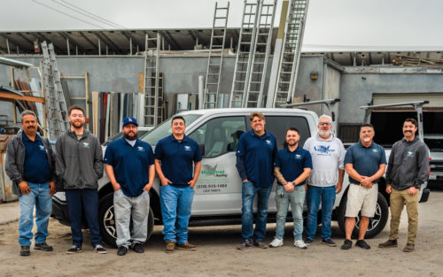 Darren Tangen, owner of Midwest Roofing Co., Inc and his employee on a job site. 